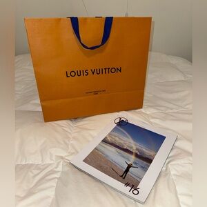 Louis Vuitton shopping bag and magazine